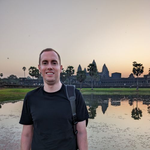 Lucas Silbernagel standing in front of Angkor Wat at sunrise
